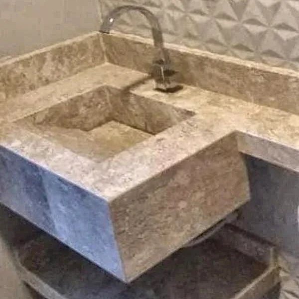 Lavabo com cuba esculpida em pedra feito pela Nova Art